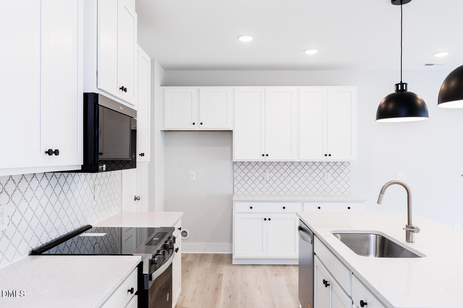 35 Silver Pne Drive Angier, NC 27501 - Photo 10 of 41 a kitchen with stainless steel appliances a stove a sink and white cabinets