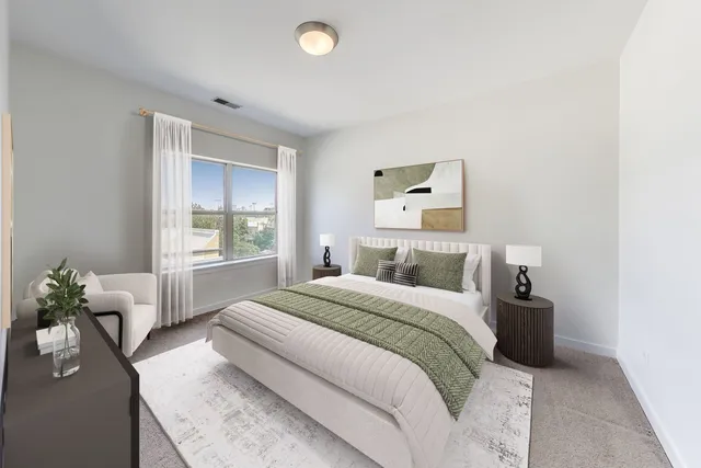 a bedroom with a bed and window