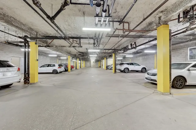 a view of parking garage with cars