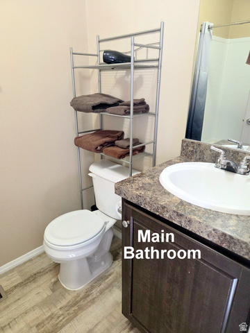 0 Nutter Avenue Thompson, UT 84540 - Photo 10 of 44 Bathroom featuring a single vanity with a dark wood-finish cabinet and speckled countertop