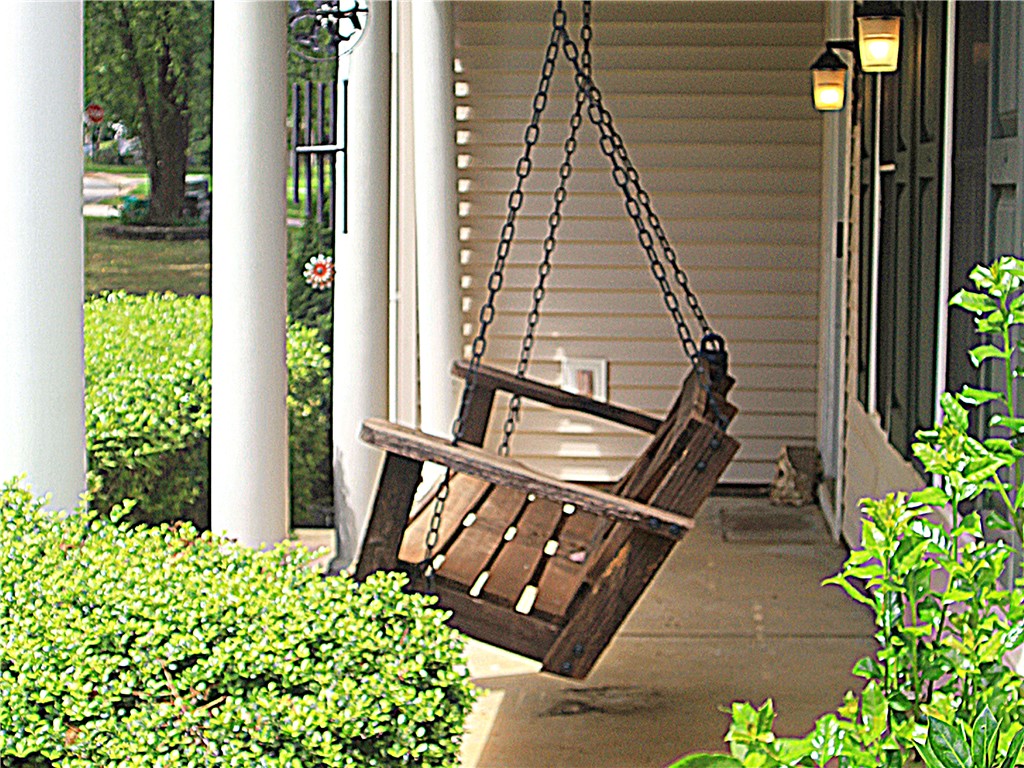 328 Springfield Circle Easley, SC 29642 - Photo 3 of 29 A classic wooden swing invites relaxation on the welcoming front porch.