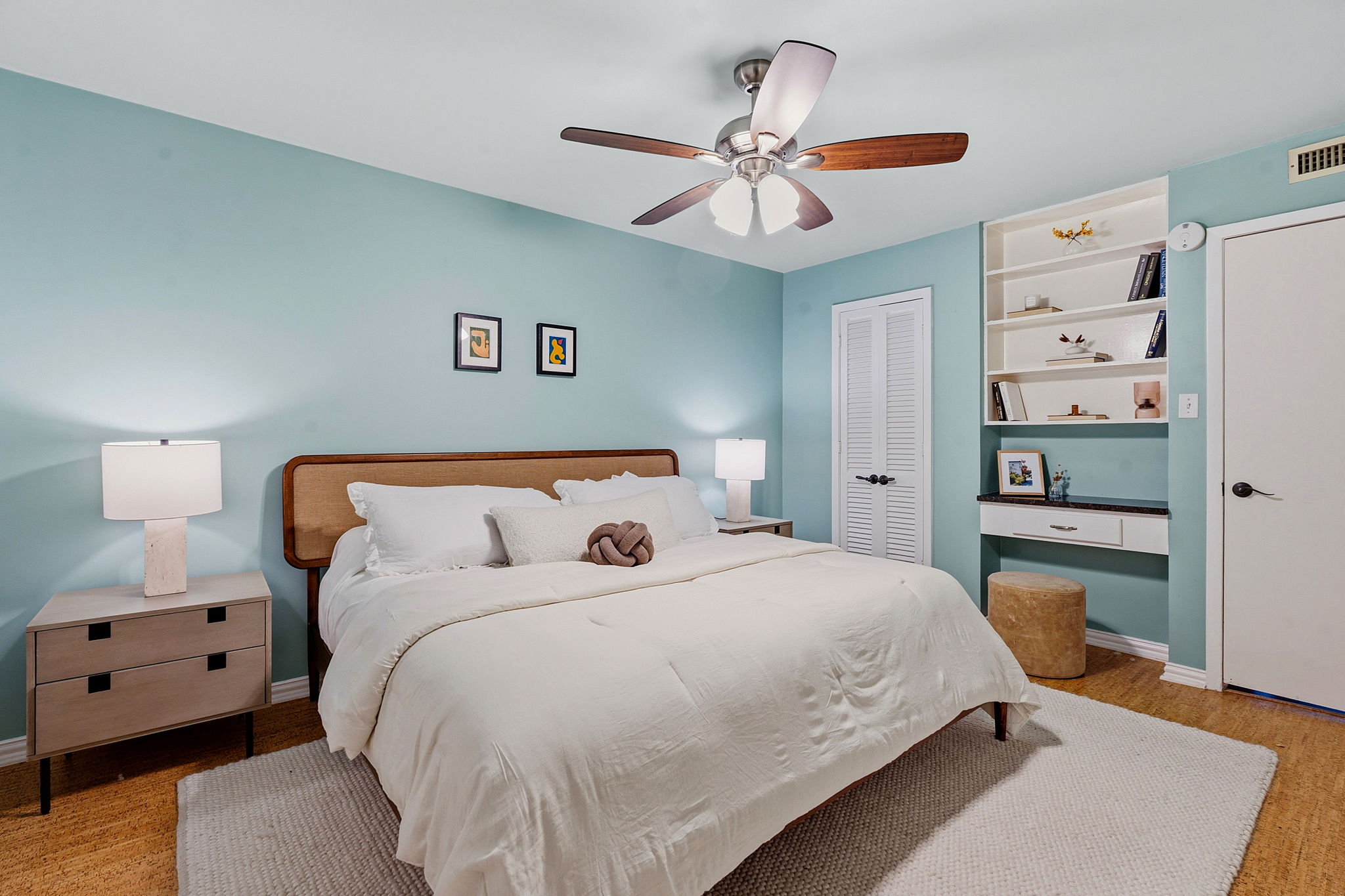 1210 Windsor Road, Unit 104 Austin, TX 78703 - Photo 15 of 29 Relax in this tranquil bedroom, featuring a warm wooden headboard and a practical built-in desk.