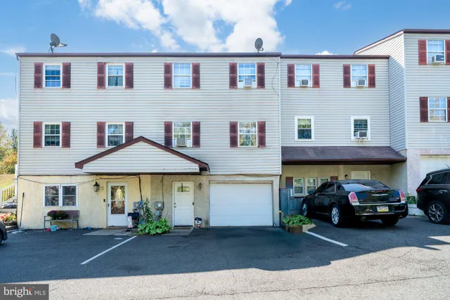a front view of a house with a yard and table