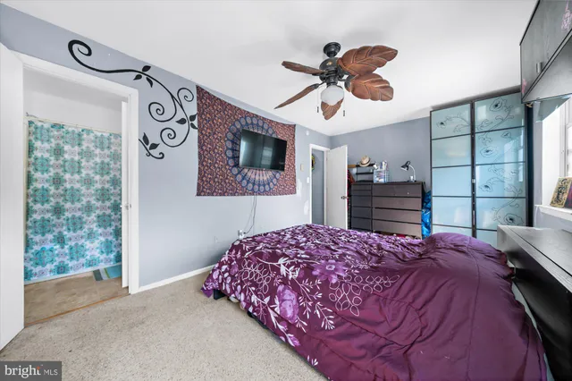 a bedroom with a bed and dresser with mirror