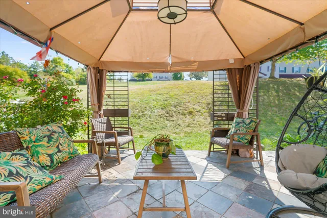 a view of a patio with a table and chairs under an umbrella