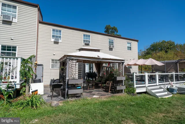 a view of a house with a yard and sitting area