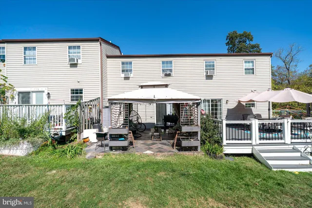 a view of a house with backyard porch and sitting area