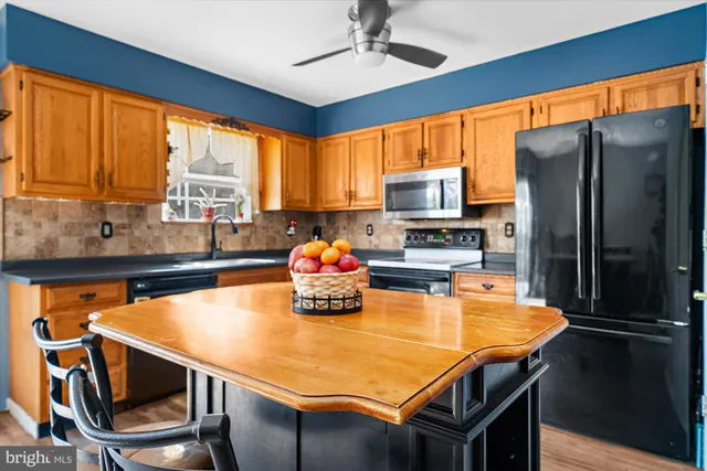 a kitchen with a table chairs stove and refrigerator