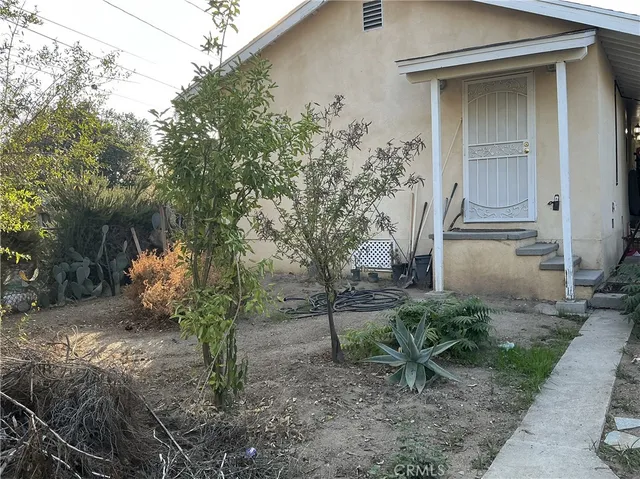 a backyard of a house with plants and trees