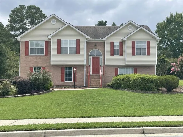 a front view of a house with a yard