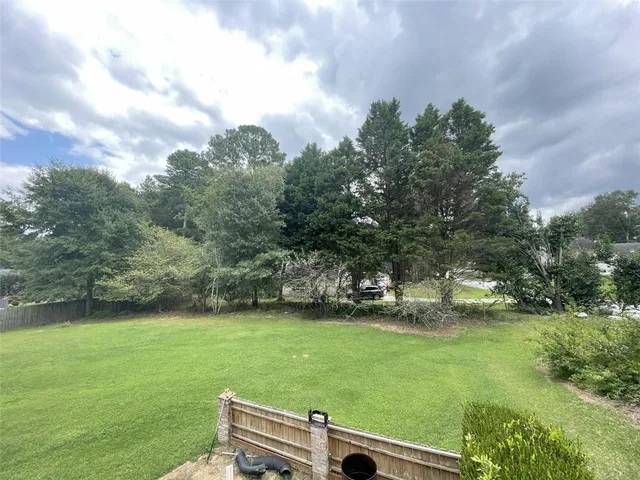 a view of a field of grass and trees