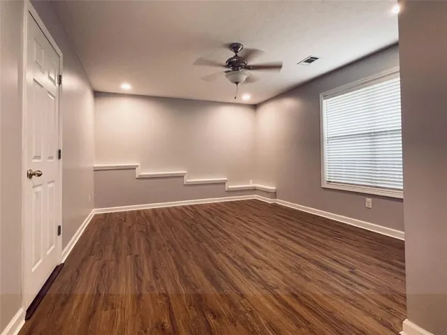 wooden floor in an empty room with a window