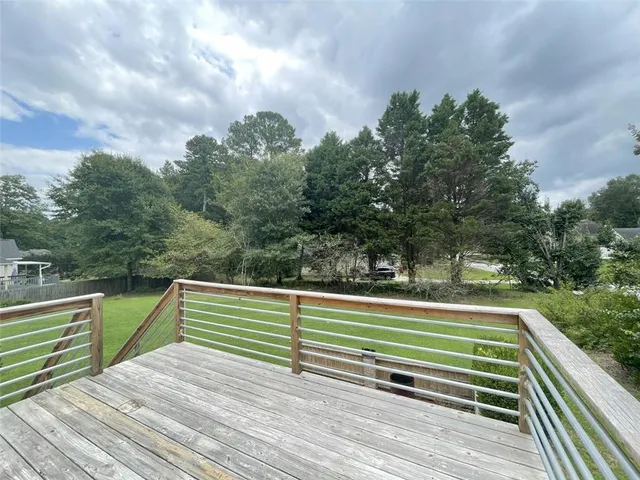a view of outdoor space with deck and yard