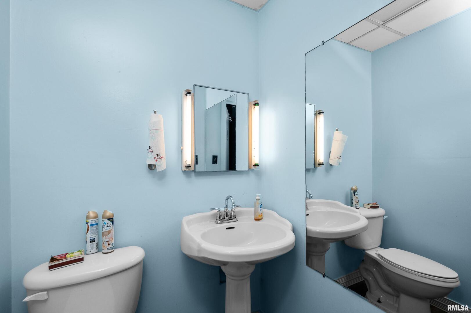 309 Main Street Savanna, IL 61074 - Photo 18 of 58 a bathroom with a toilet sink and mirror