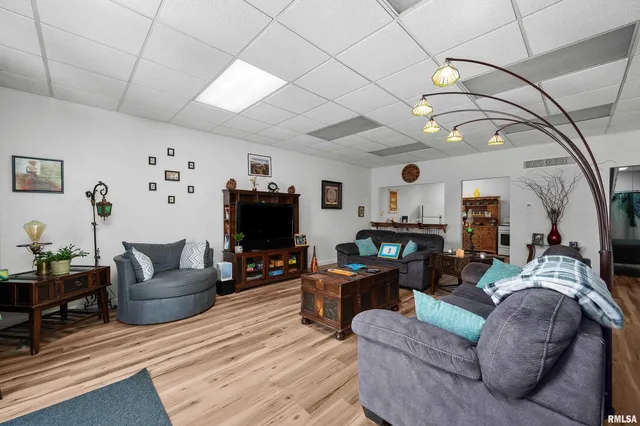 a kitchen with a sink cabinets and wooden floor