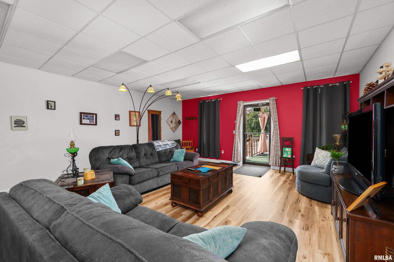 309 Main Street Savanna, IL 61074 - Photo 22 of 58 a living room with furniture a flat screen tv and a large window