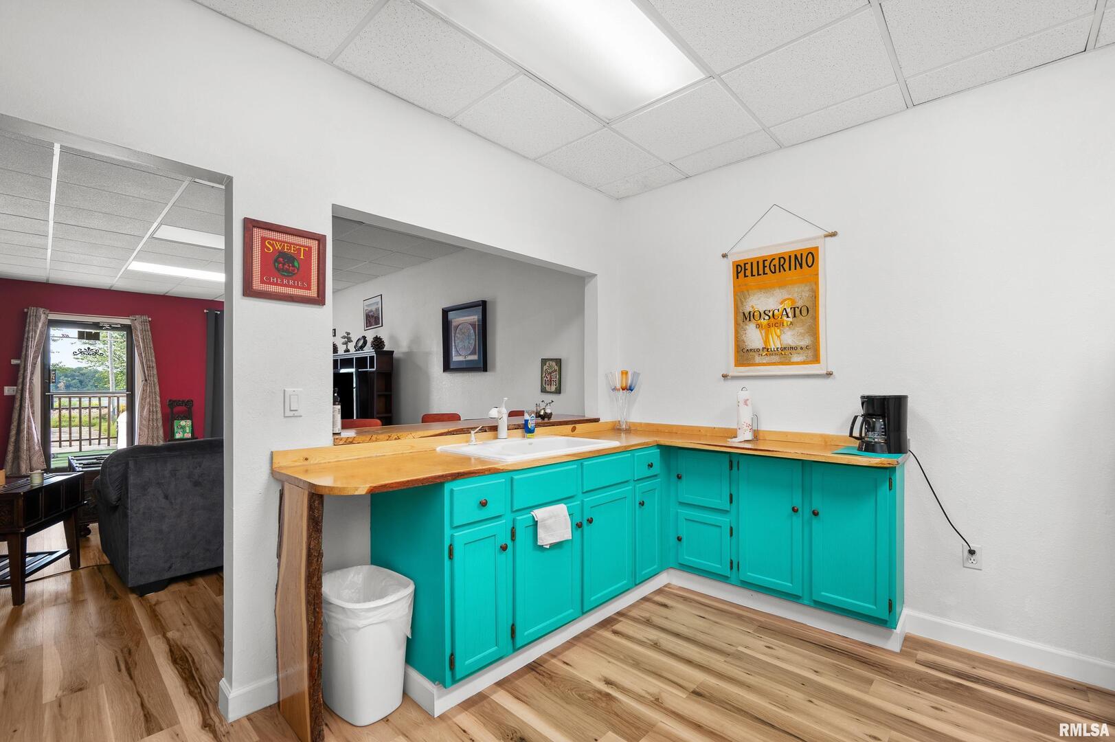 309 Main Street Savanna, IL 61074 - Photo 24 of 58 a kitchen with a sink cabinets and wooden floor