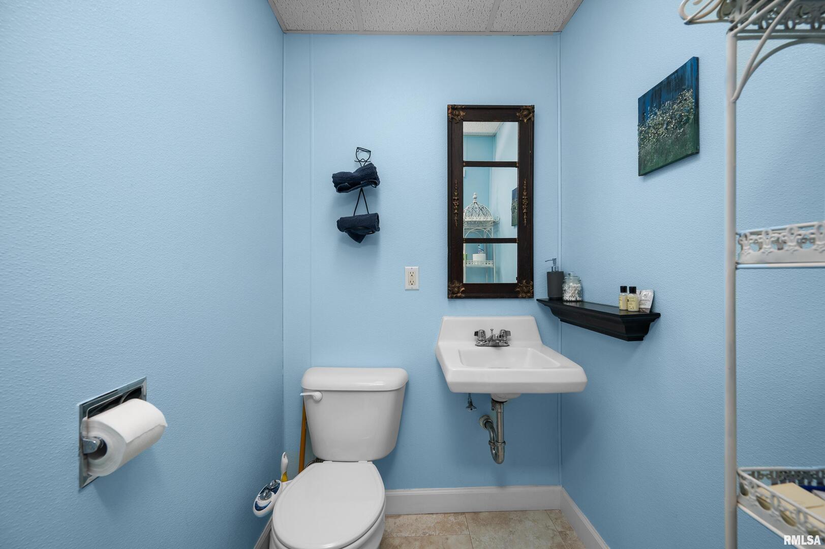 309 Main Street Savanna, IL 61074 - Photo 31 of 58 a bathroom with a toilet a sink and mirror