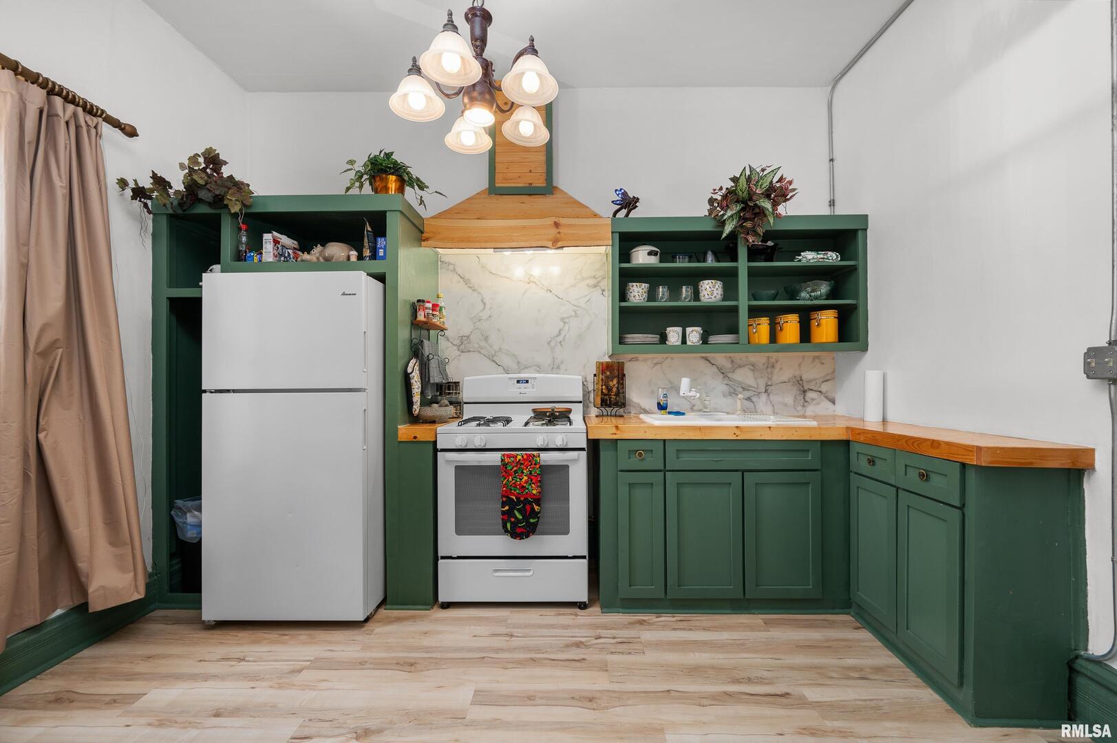 309 Main Street Savanna, IL 61074 - Photo 34 of 58 a kitchen with stainless steel appliances granite countertop a refrigerator a stove and a sink