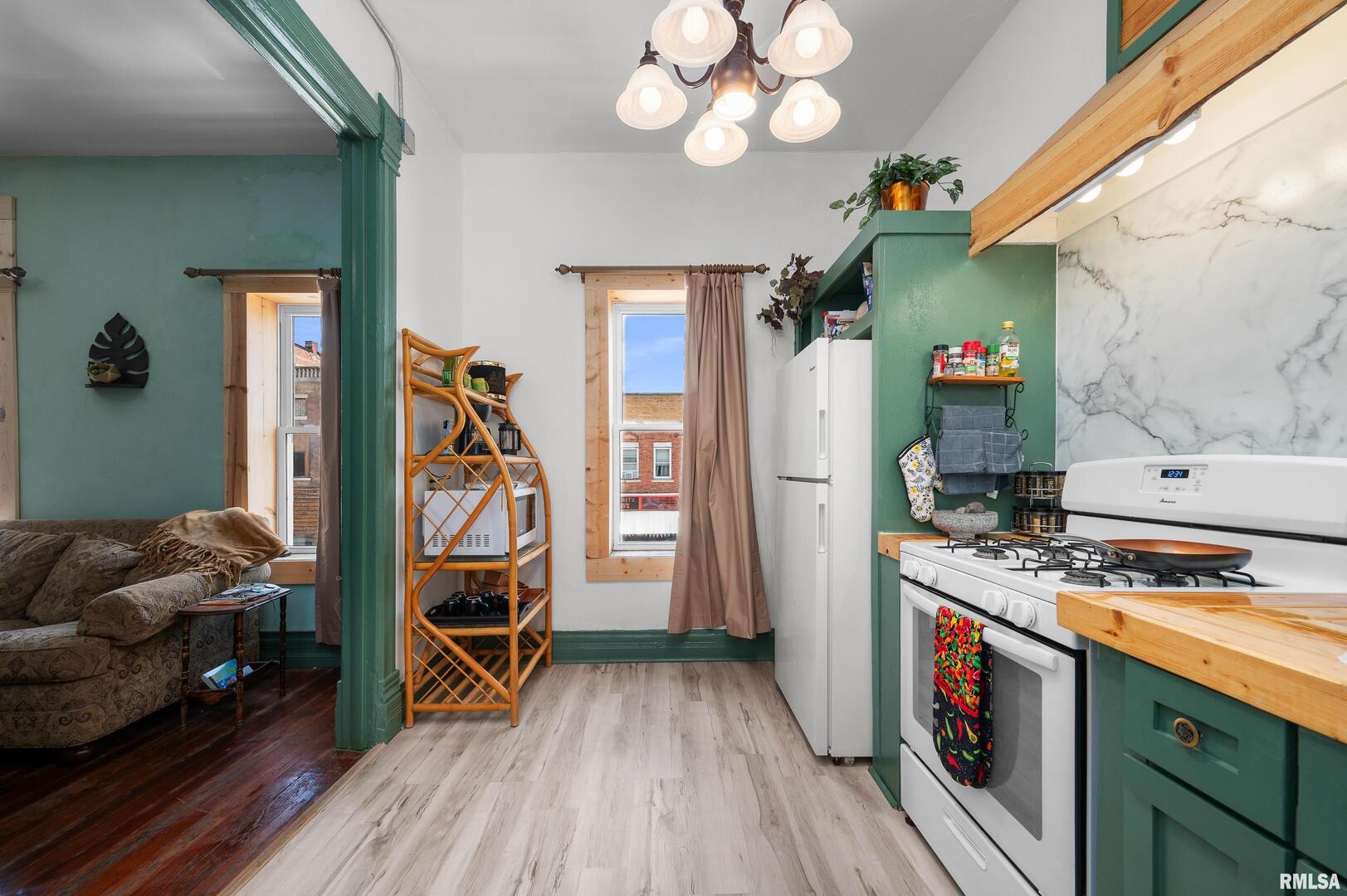309 Main Street Savanna, IL 61074 - Photo 35 of 58 a kitchen with stainless steel appliances granite countertop a stove and cabinets