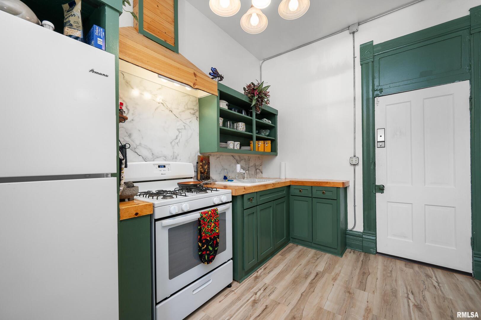 309 Main Street Savanna, IL 61074 - Photo 36 of 58 a kitchen with stainless steel appliances granite countertop a stove and a refrigerator