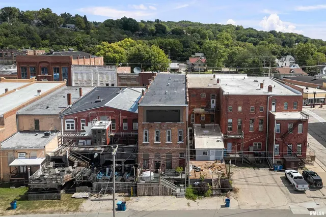 a front view of a building with sitting area