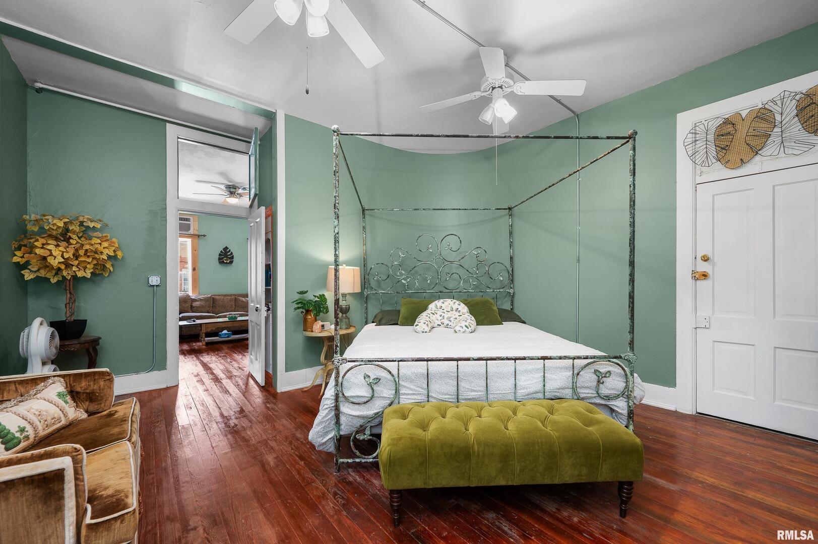 309 Main Street Savanna, IL 61074 - Photo 41 of 58 a bedroom with a bed and a chandelier