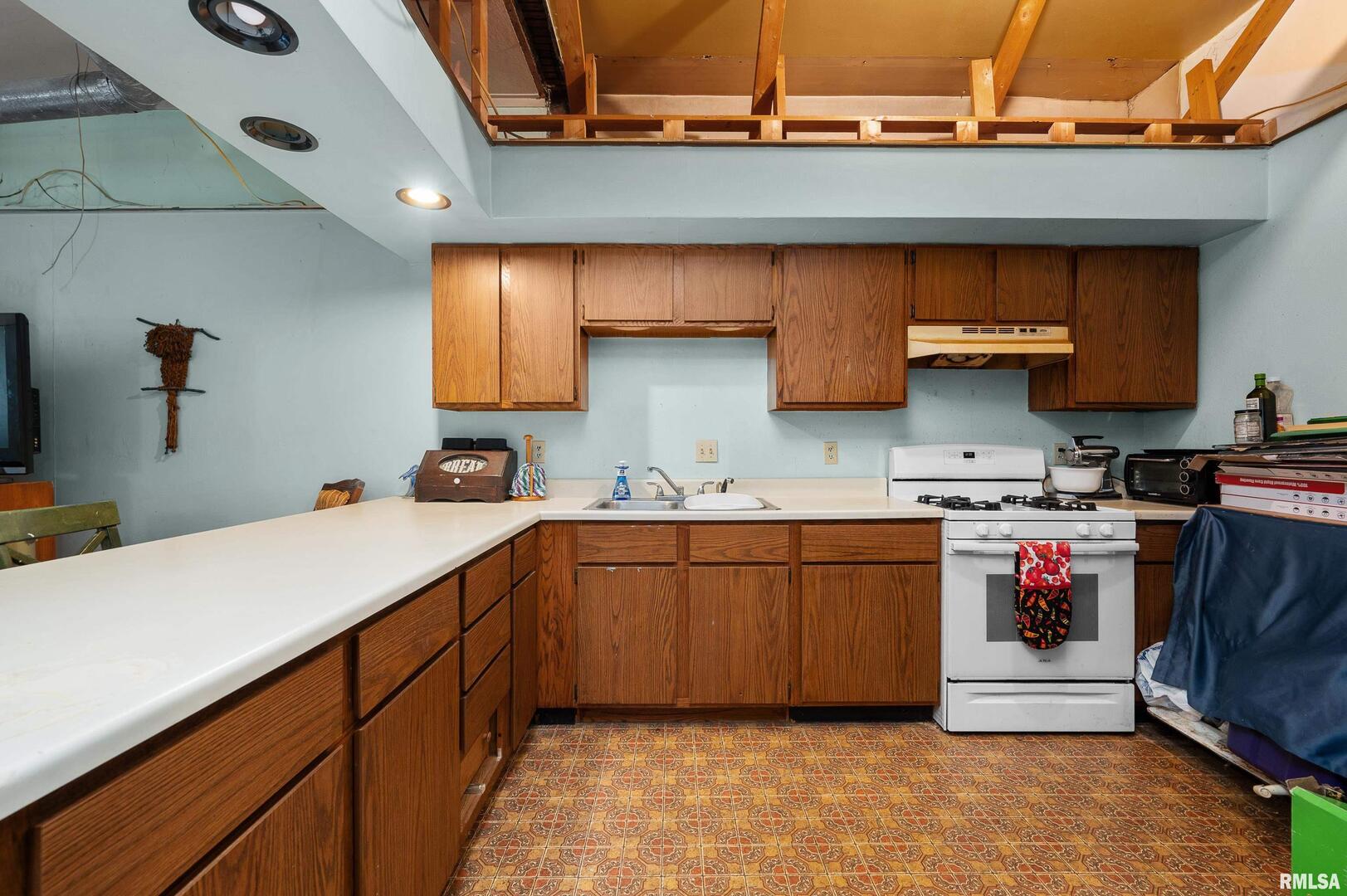 309 Main Street Savanna, IL 61074 - Photo 47 of 58 a kitchen with stainless steel appliances granite countertop a sink and cabinets