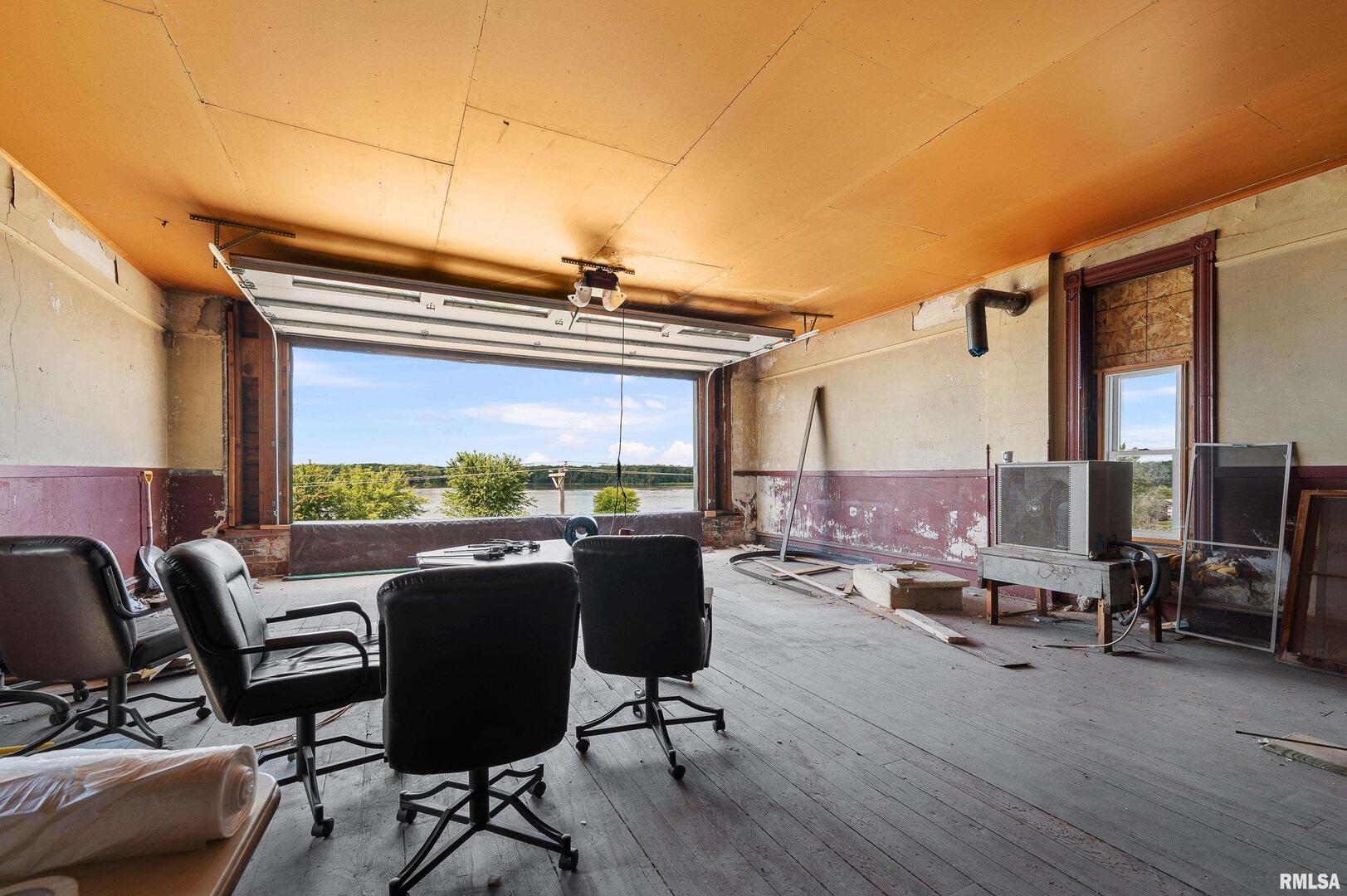 309 Main Street Savanna, IL 61074 - Photo 55 of 58 a view of a workspace with furniture and a floor to ceiling window
