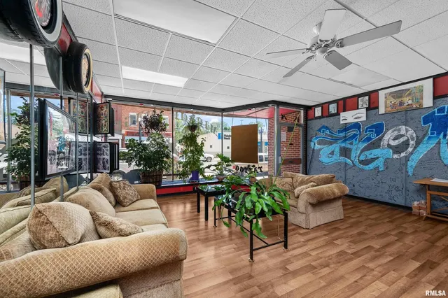 a view of a room with lots of furniture and lots of wooden floor