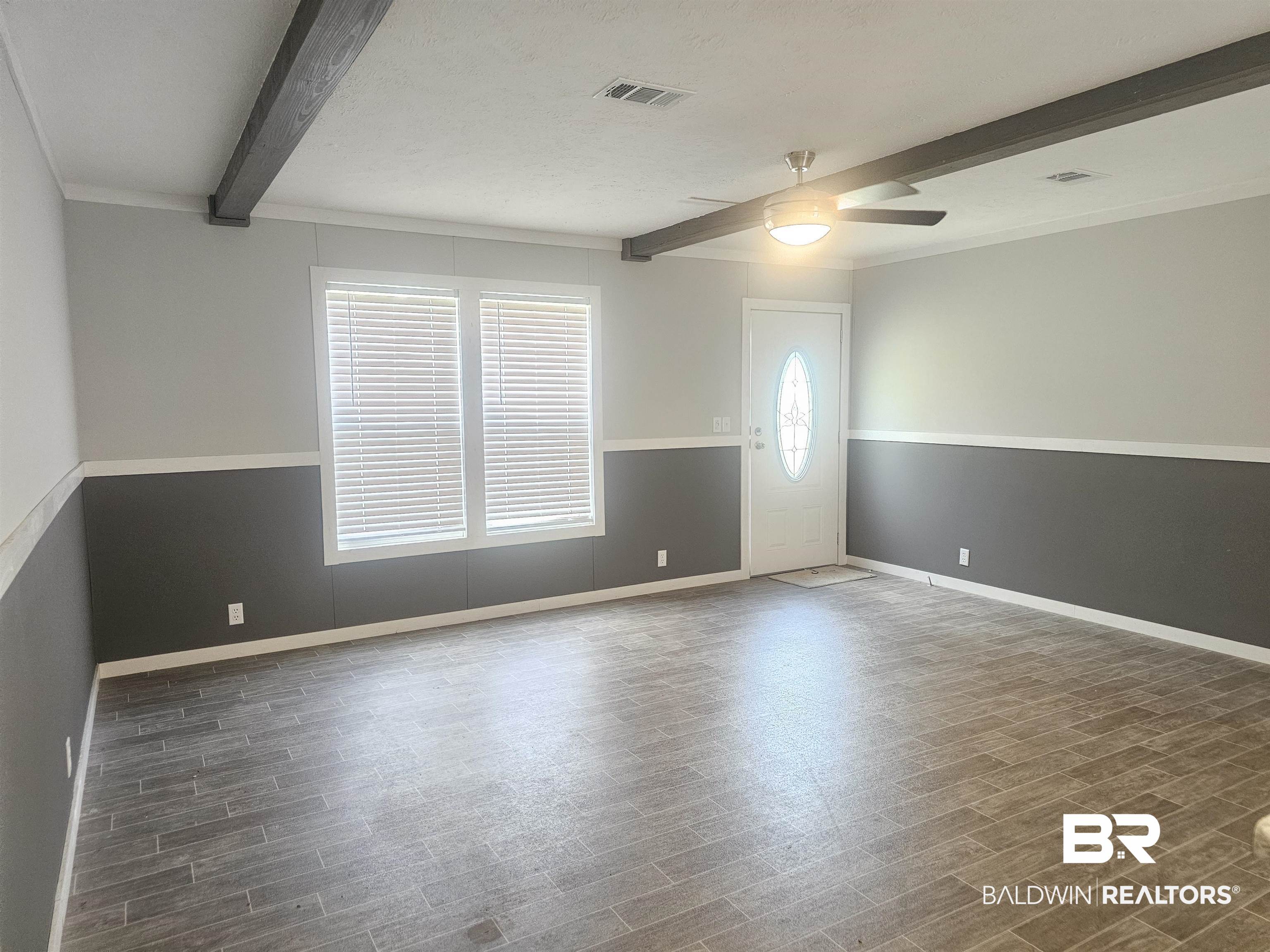 1863 Wait Road Monroeville, AL 36460 - Photo 32 of 38 Unfurnished room with ceiling fan, beamed ceiling, dark hardwood / wood-style floors, and crown molding