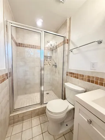 a bathroom with a shower a toilet and a shower