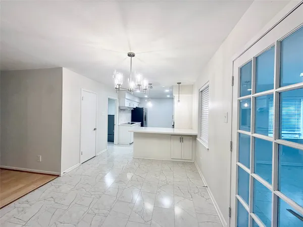 a view of a kitchen with refrigerator and windows
