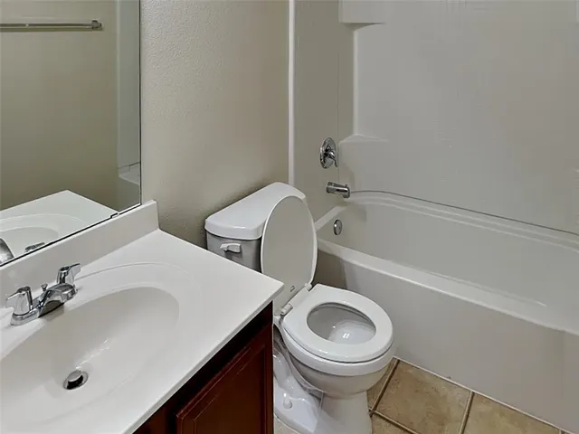 a bathroom with a sink a toilet and bathtub