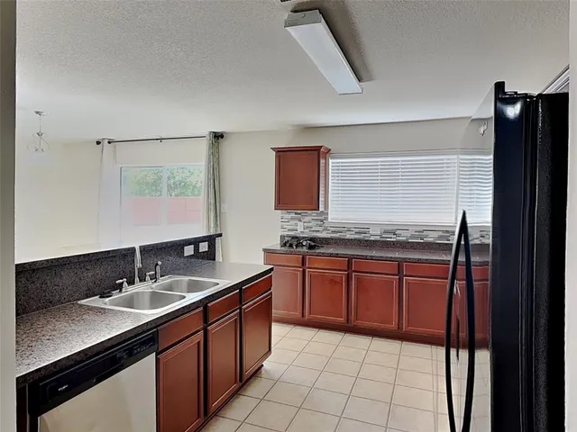 a spacious bathroom with a granite countertop sink and a mirror