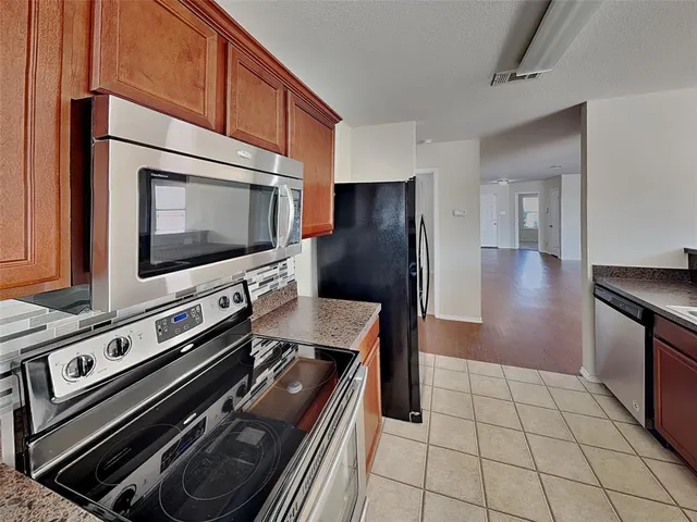 a kitchen with a stove and a microwave