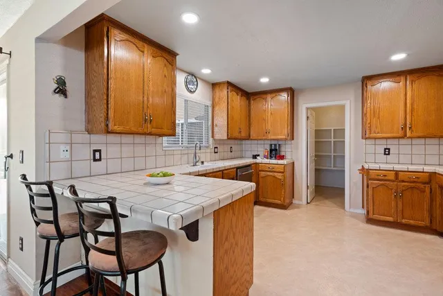 a kitchen with a stove a sink and a refrigerator