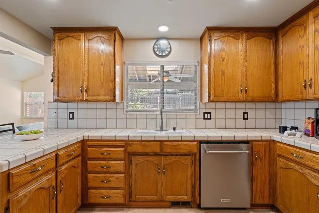 a kitchen with cabinets appliances and a sink