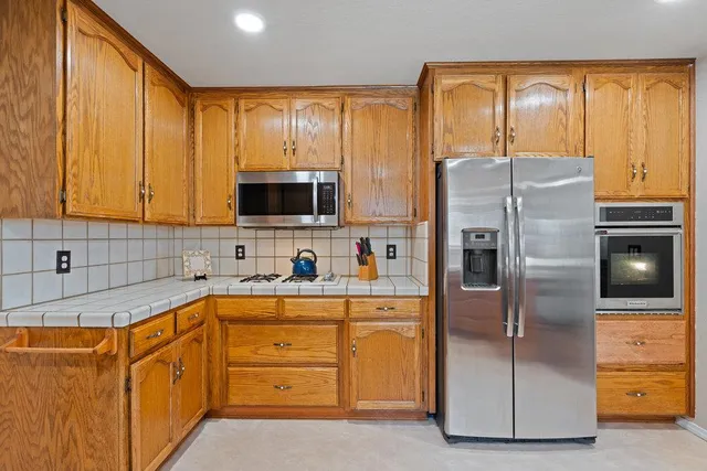 a kitchen with stainless steel appliances a refrigerator sink and cabinets