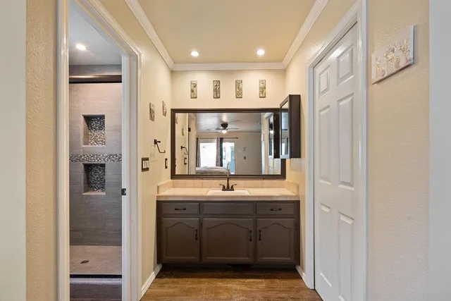 a bathroom with a sink a mirror and a shower