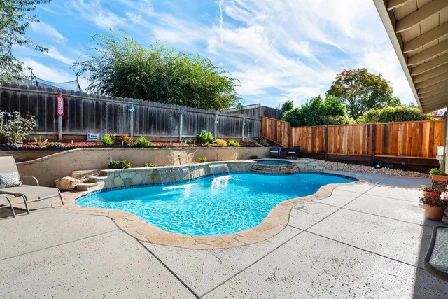 a swimming pool with wooden fence