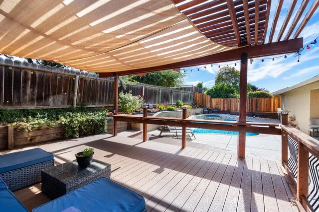 a reading room with wooden floor and outdoor seating