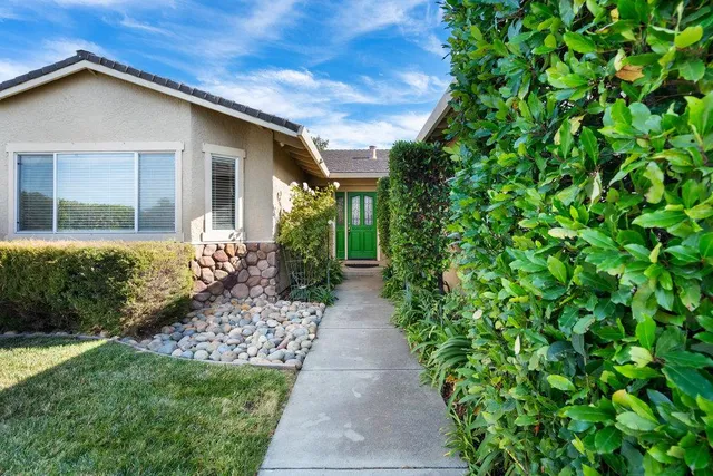 a front view of a house with garden