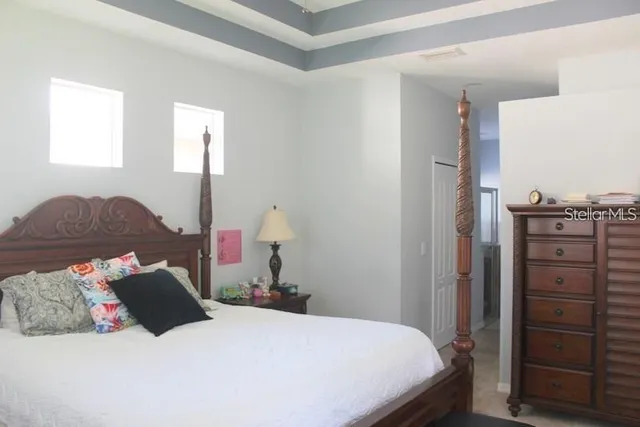 a bedroom with a bed and window