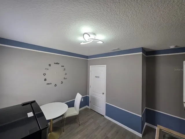 a view of a hallway with furniture and wooden floor