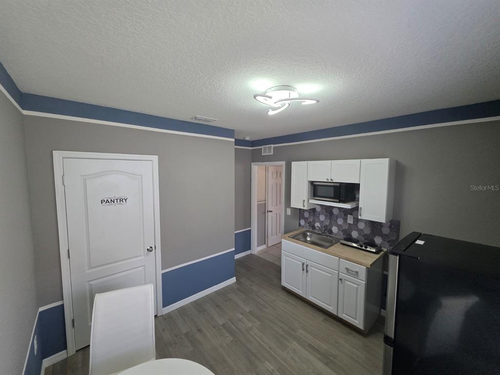 981 Chanler Drive Haines City, FL 33844 - Photo 7 of 11 a kitchen with a sink and a stove top oven