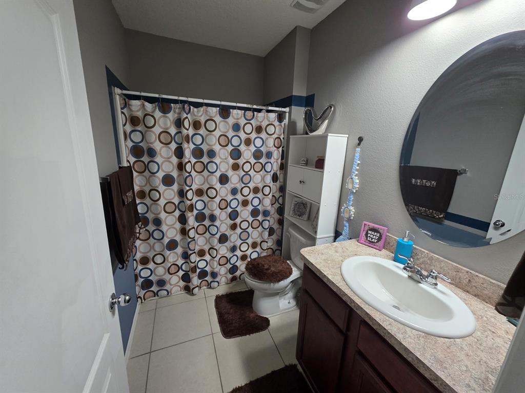 981 Chanler Drive Haines City, FL 33844 - Photo 9 of 11 a bathroom with a sink toilet and shower