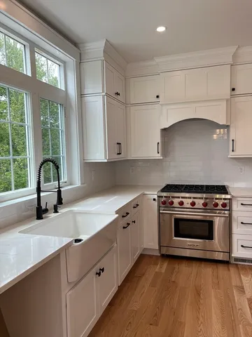 a kitchen with granite countertop a stove and a sink