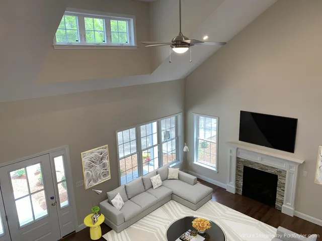 a living room with furniture a fireplace and a flat screen tv