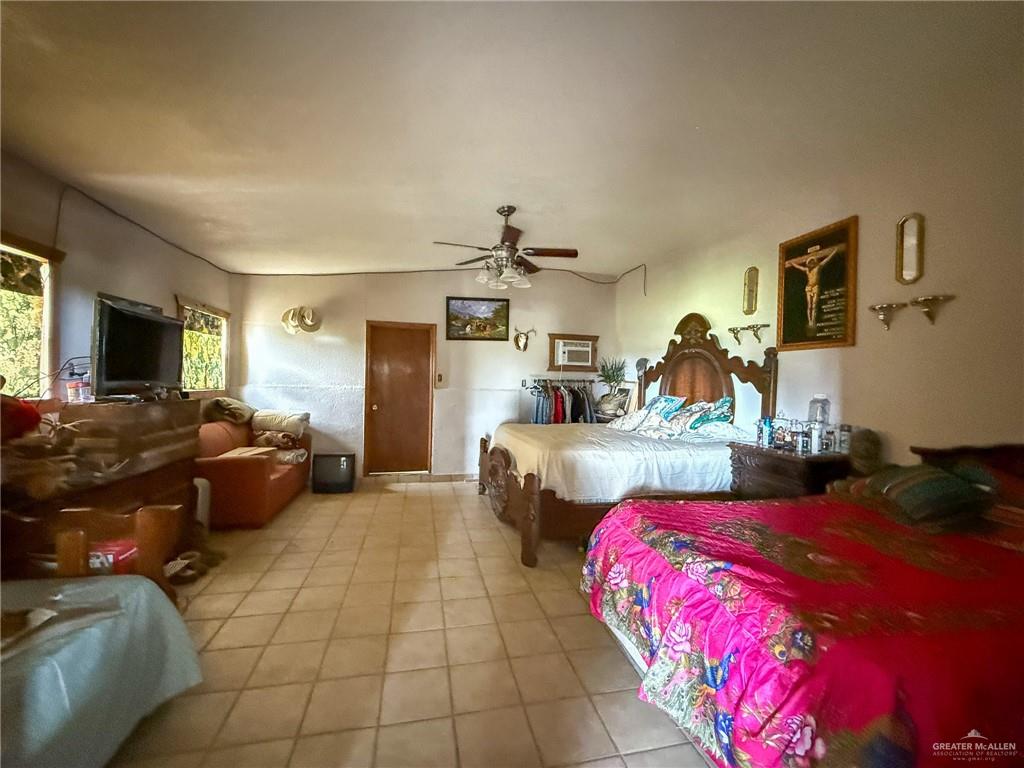 9 San Julian Road Roma, TX 78584 - Photo 11 of 28 a bedroom with a bed and a couch